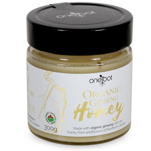 Glass jar of OneRoot Organic Ginseng Honey with Canadian organic badge, indicating a blend of raw honey from Northern Canada's wildflowers and organic ginseng.