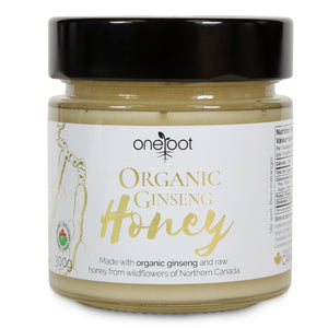 Close-up of OneRoot Organic Ginseng Honey jar showcasing the Canadian organic emblem, detailed with a blend of raw honey derived from Northern Canada's wildflowers and organic ginseng, accompanied by partial nutrition label.